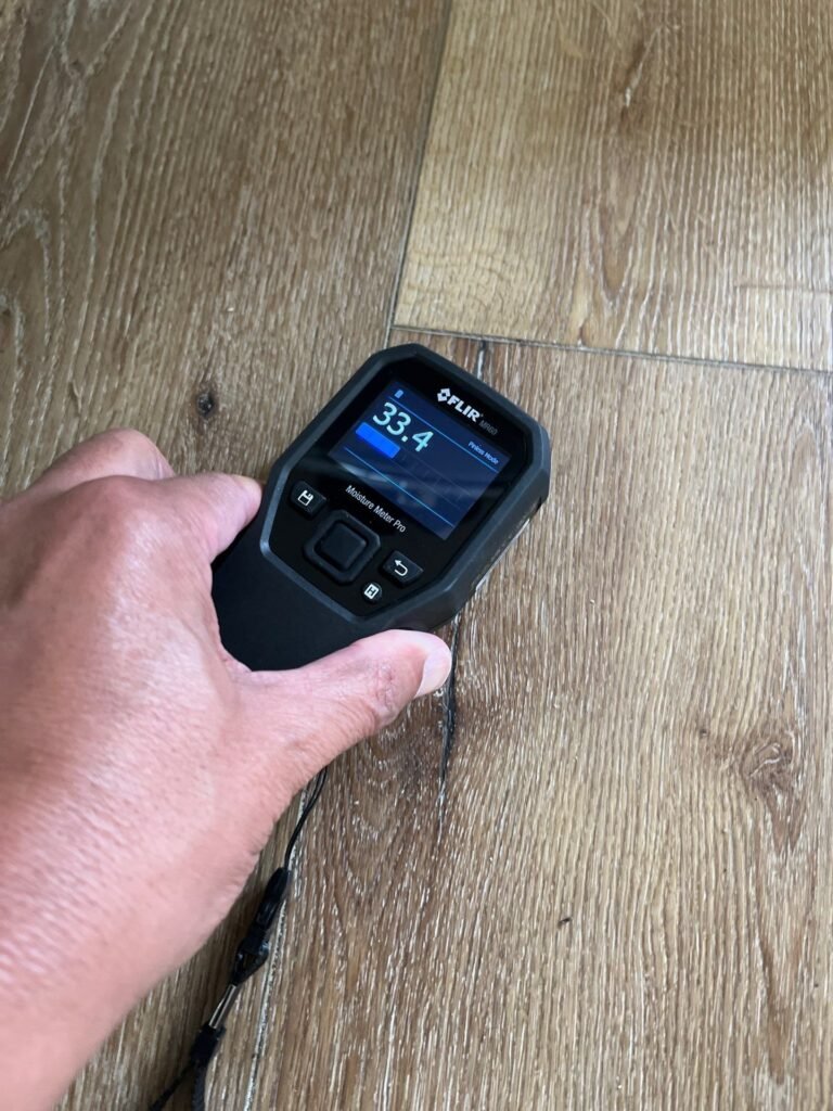 Moisture meter reading taken on a vinyl plank floor in a Santa Ana home