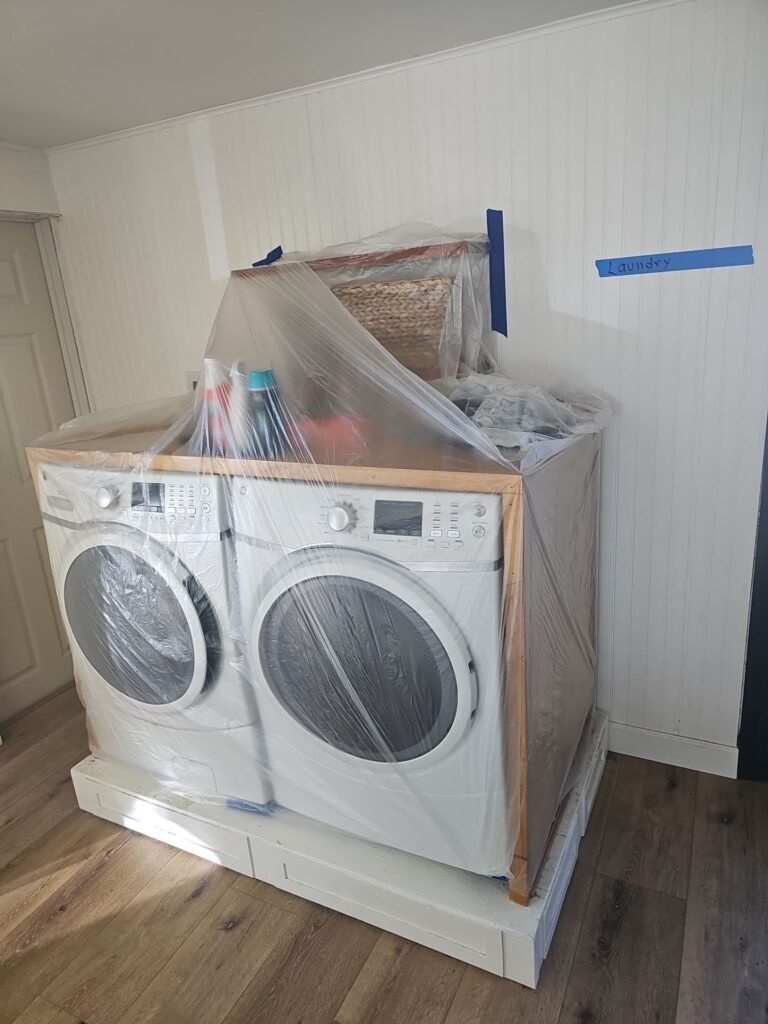 Containment set up behind a washer and dryer where a supply line failed in a Santa Ana home