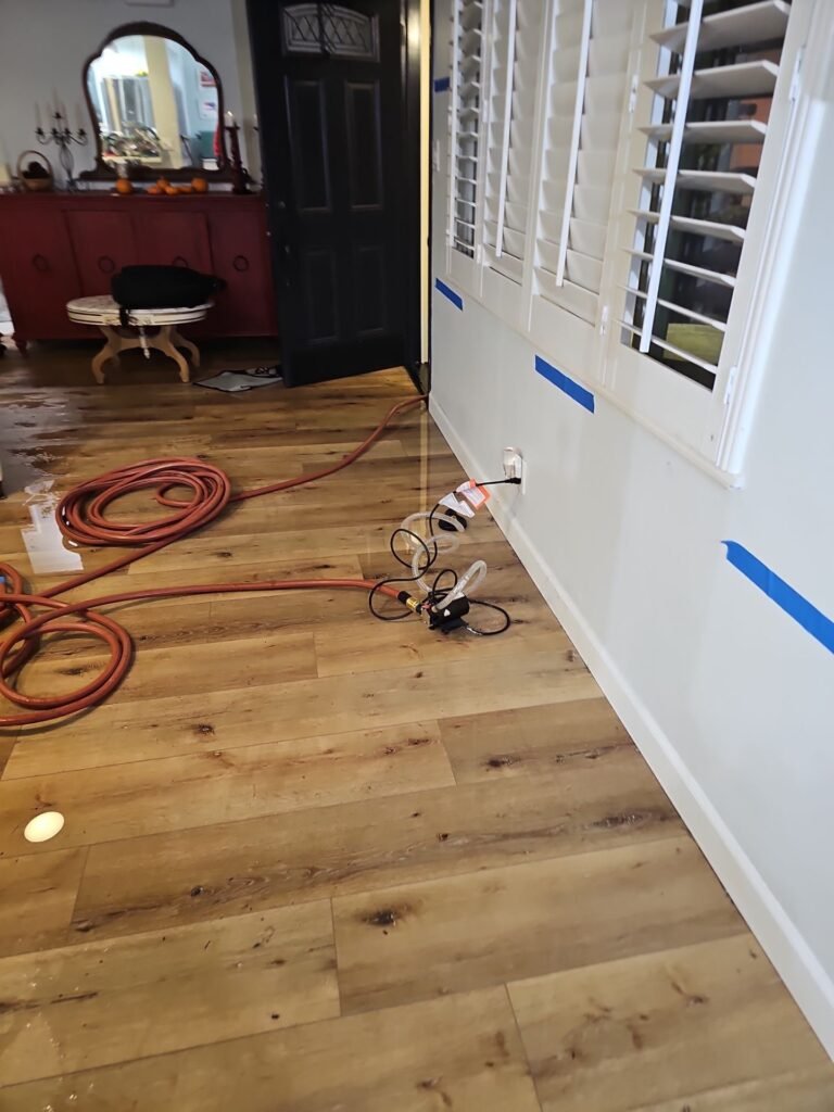 Air movers positioned in a Santa Ana bedroom with the wet area marked off