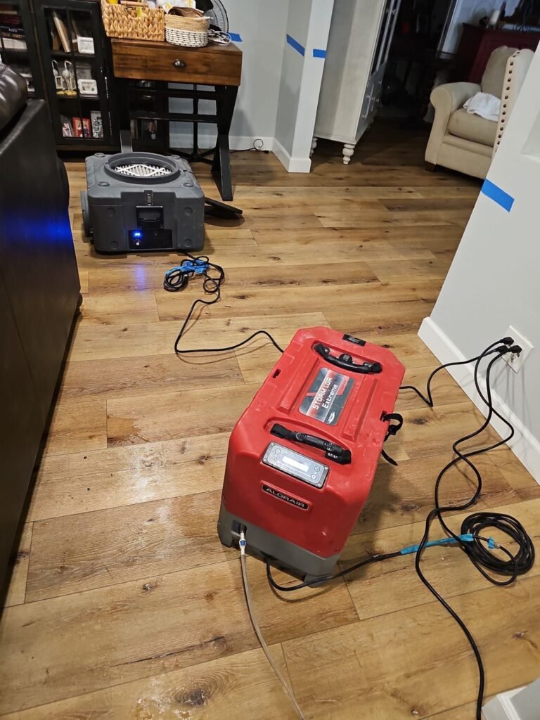 Extraction equipment running on a wet hardwood floor in Santa Ana