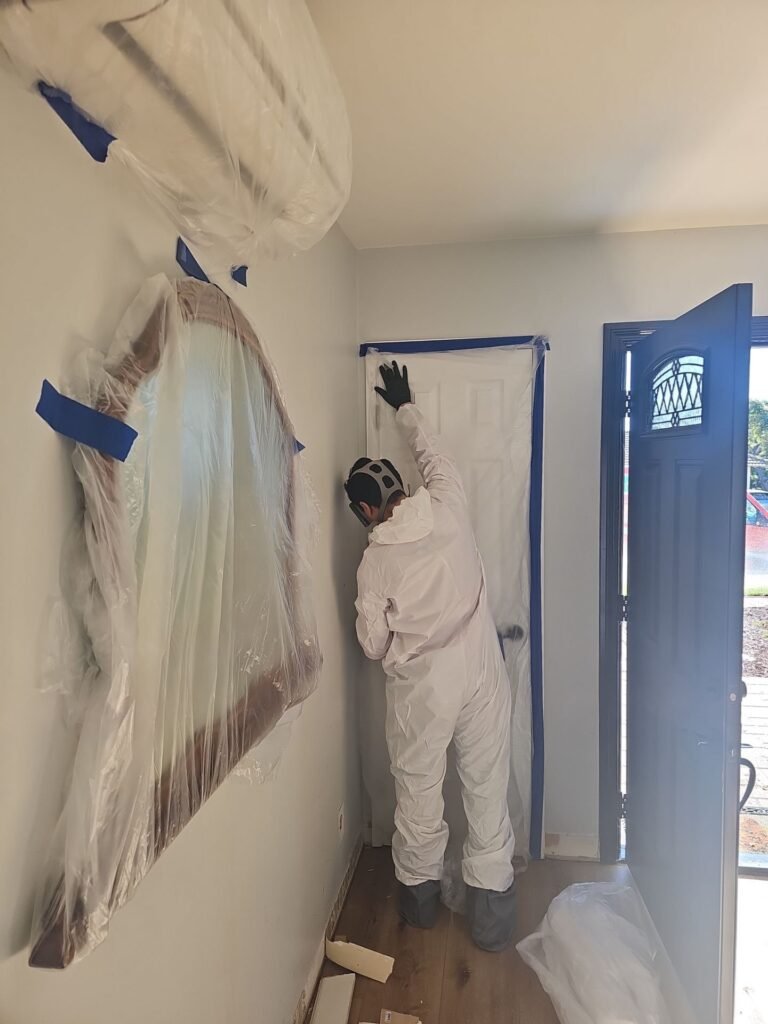 Sealed containment barrier with a zippered door isolating a mold job in Santa Ana