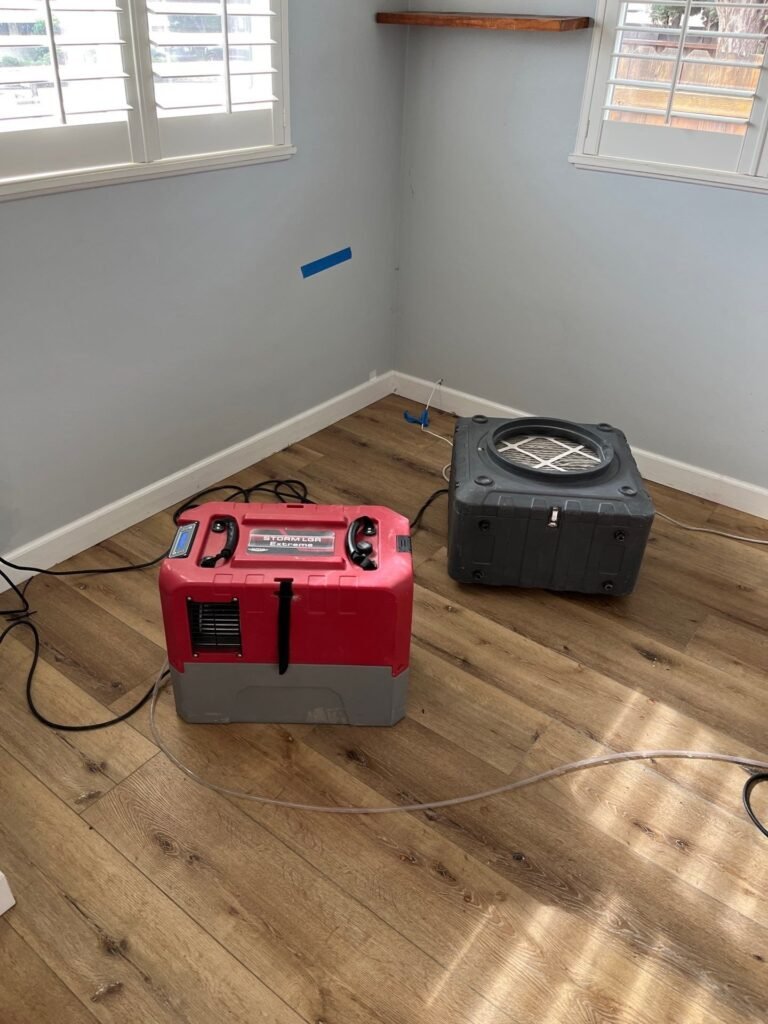 Air mover drying a bedroom wall in a Santa Ana home