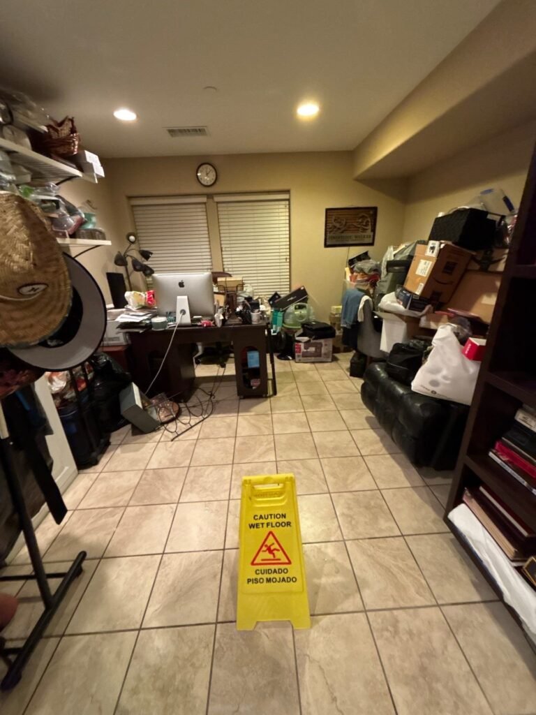 Wet floor sign placed in a Santa Ana hallway while water is removed
