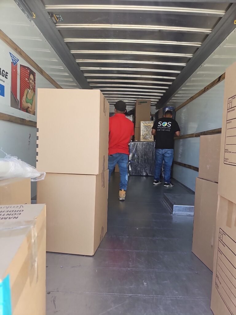 Wrapped furniture loaded for storage while a Santa Ana home is repaired