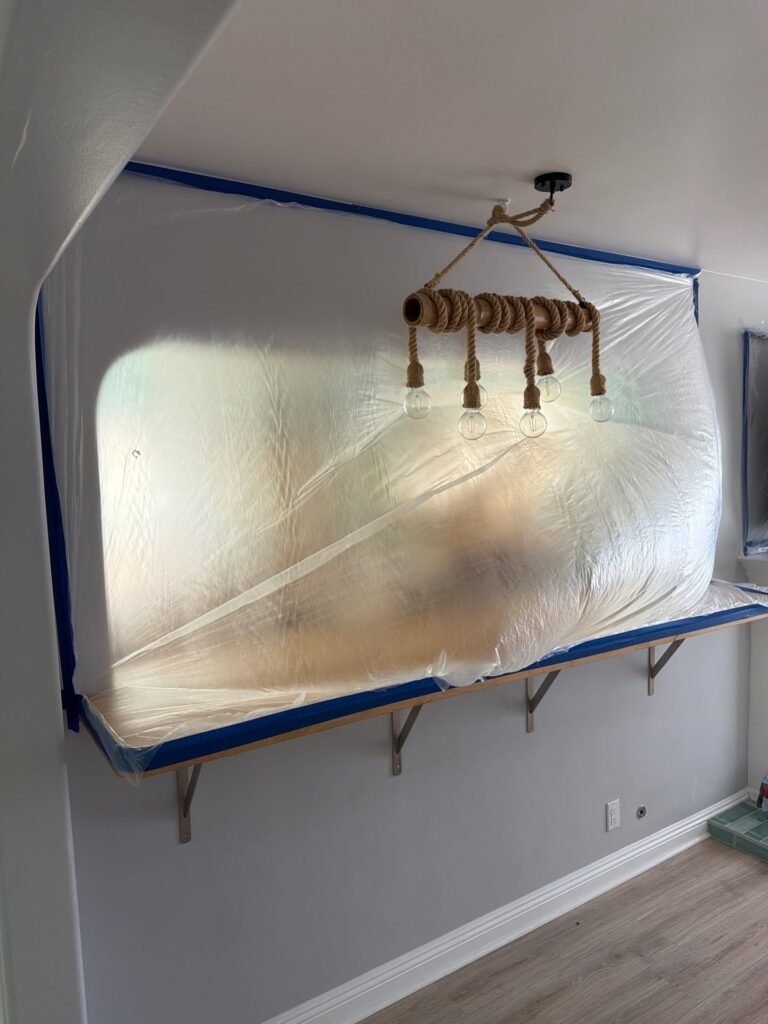 Containment plastic sealed to the ceiling around a light fixture in Santa Ana