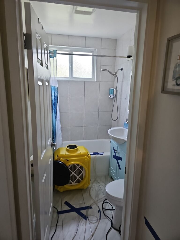 Air movers drying a Santa Ana bathroom after a leak