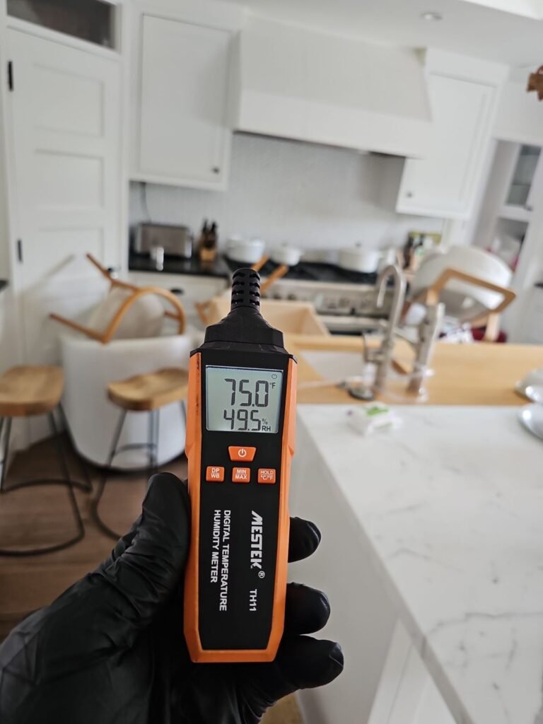A meter reading 75.0 degrees held over a marble kitchen counter in Santa Ana